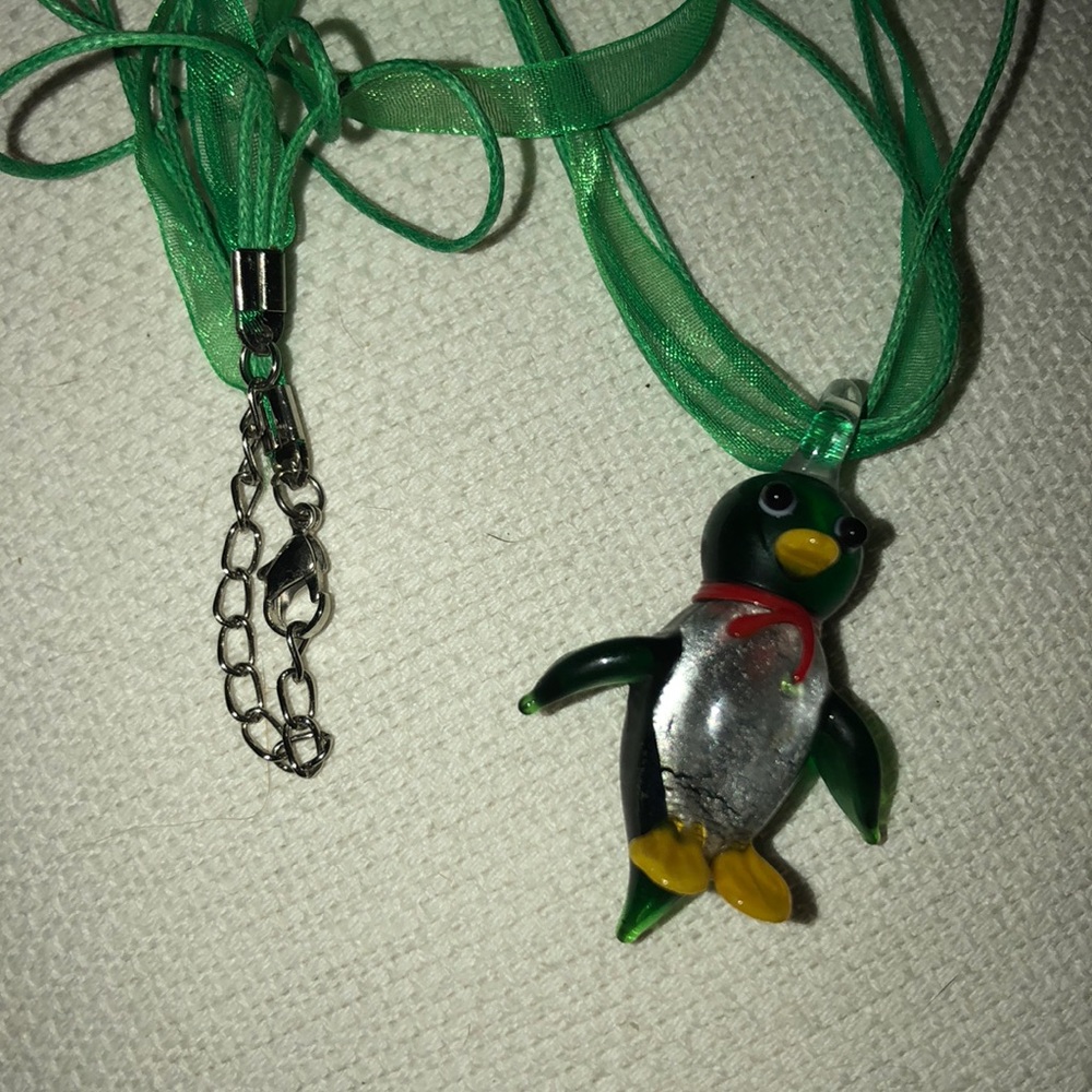 Hand blown glass green penguin necklace.